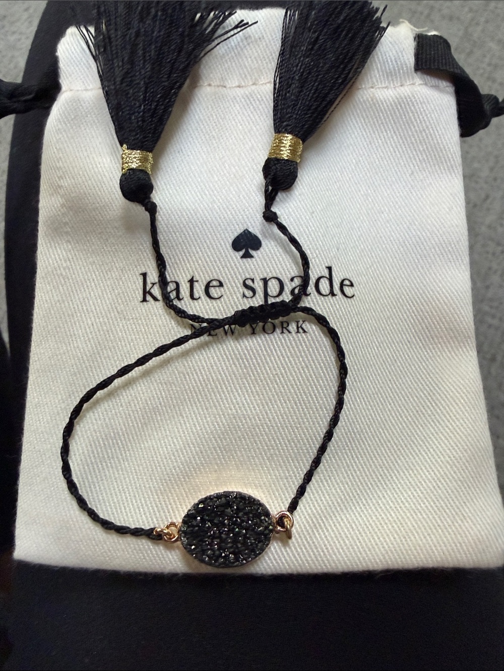 kate spade Black Crystal Oval Cord Bracelet with Gold Accents and storage pouch.